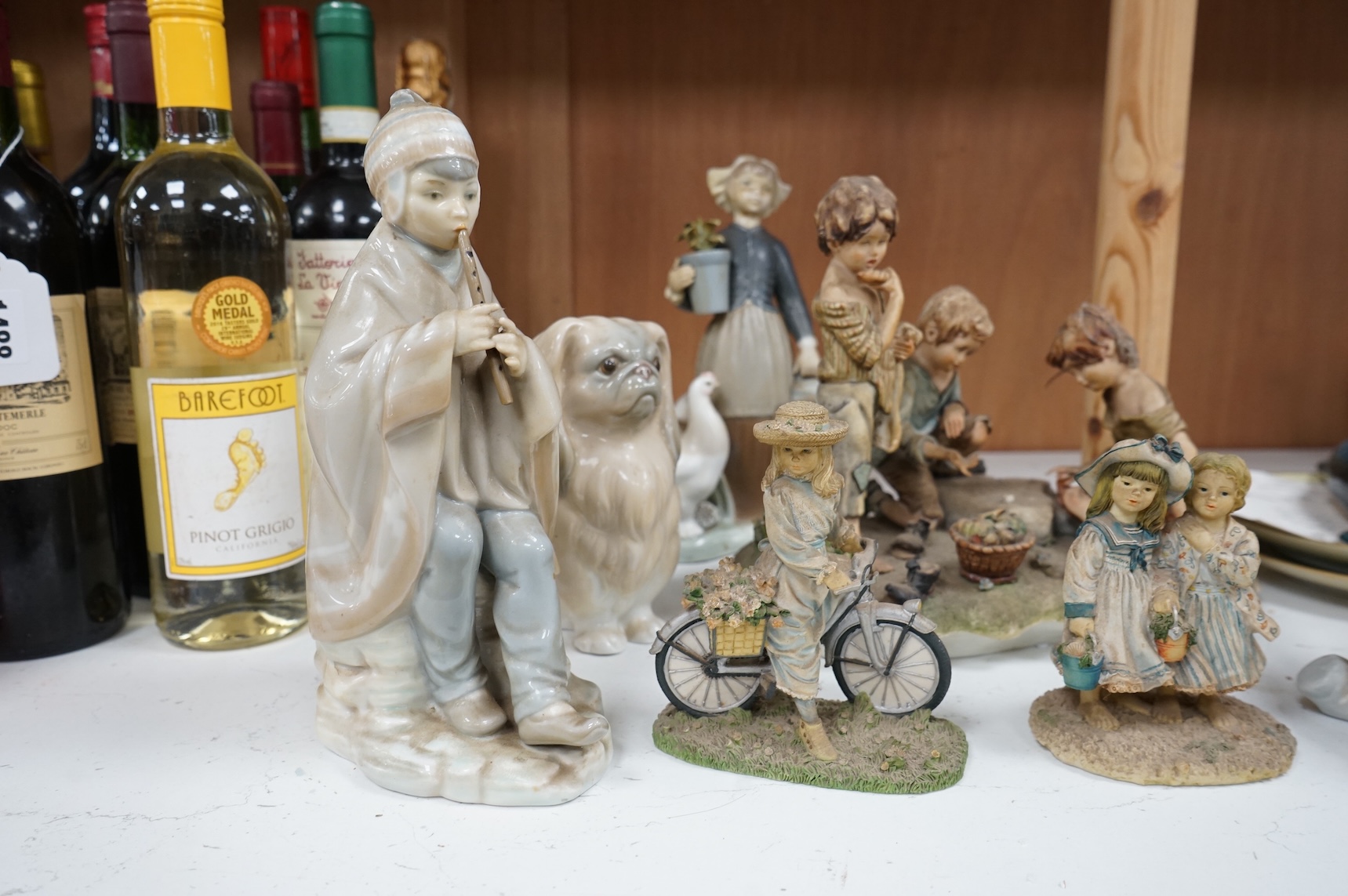 A collection of pottery and porcelain to include a Hayle model of a seal, Lladro figures and a pair of Fairy cabinet plates, largest 27cm wide
